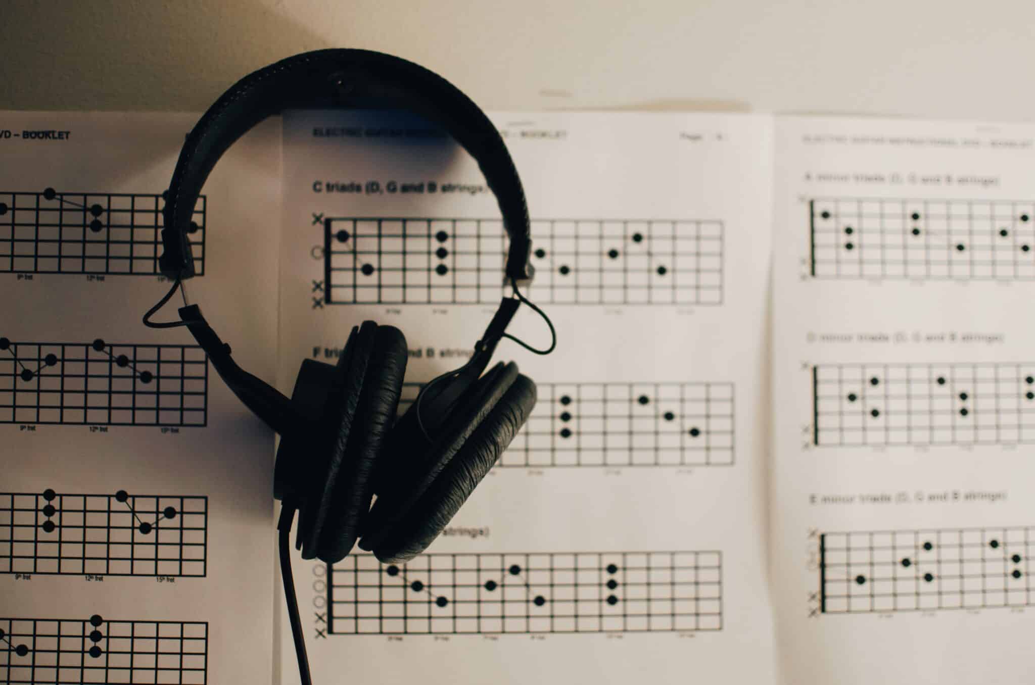 Headphones resting on sheet music