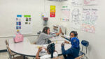 Teacher supporting young readers in a small group