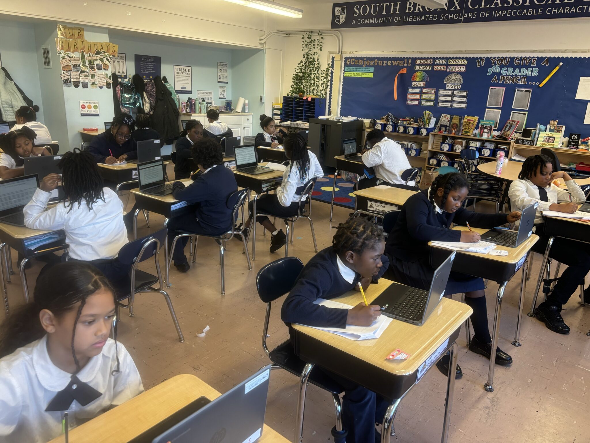 Scholars using laptops during classroom testing