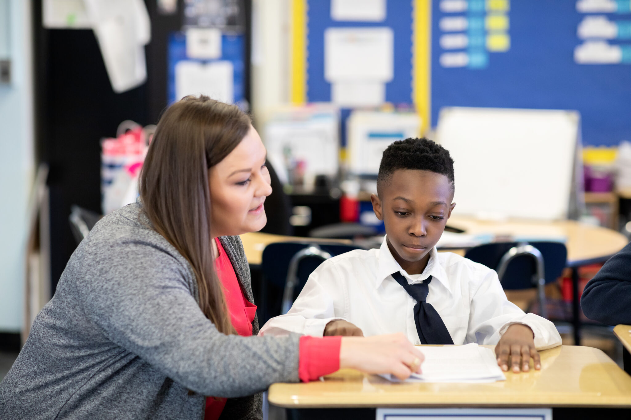 Teacher supporting a scholar during independent practice