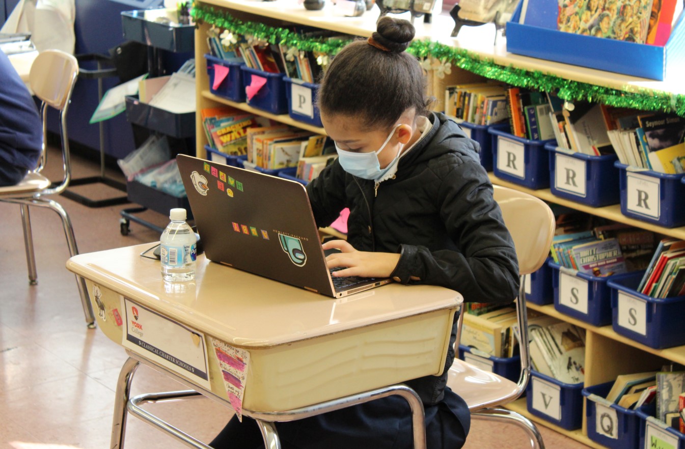 Student using a laptop during remote and in-person learning