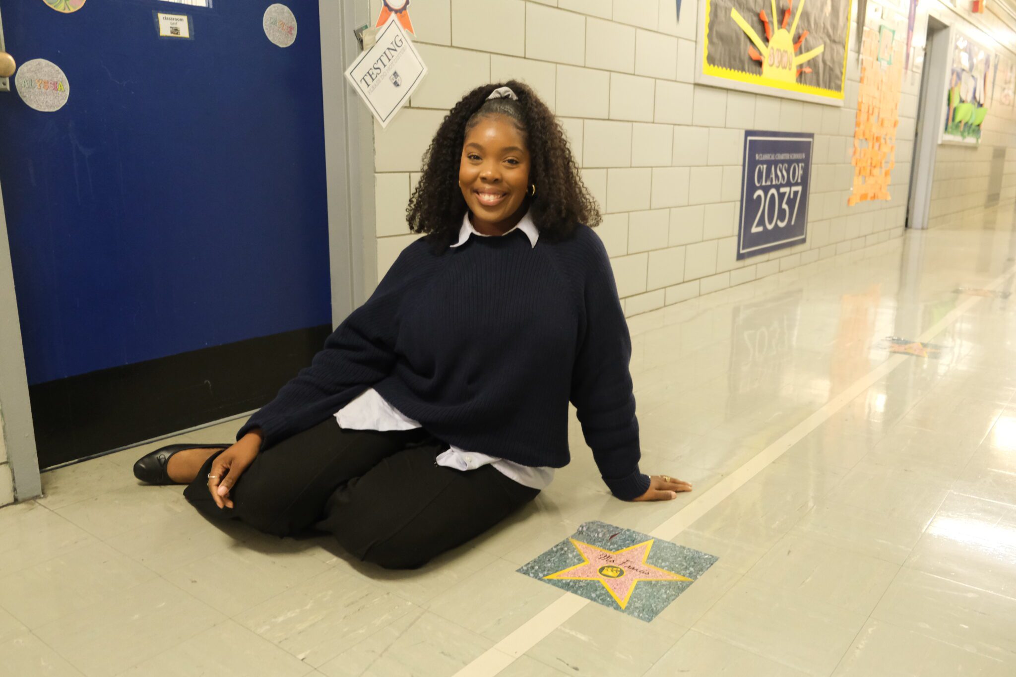 Staff member beside a hallway appreciation star