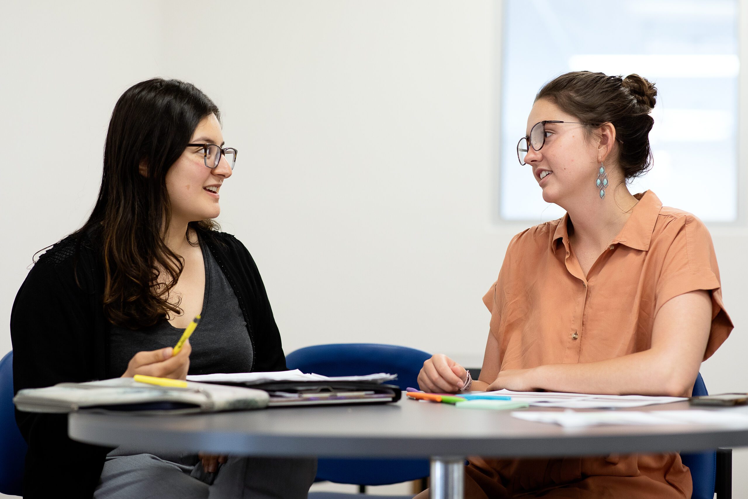 Two educators collaborating at a table