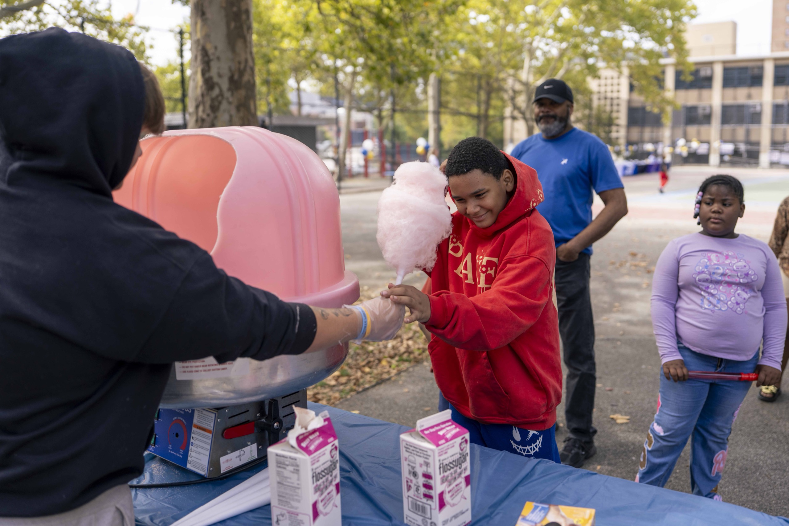 A child receives cotton candy at the Mott Haven Together event
