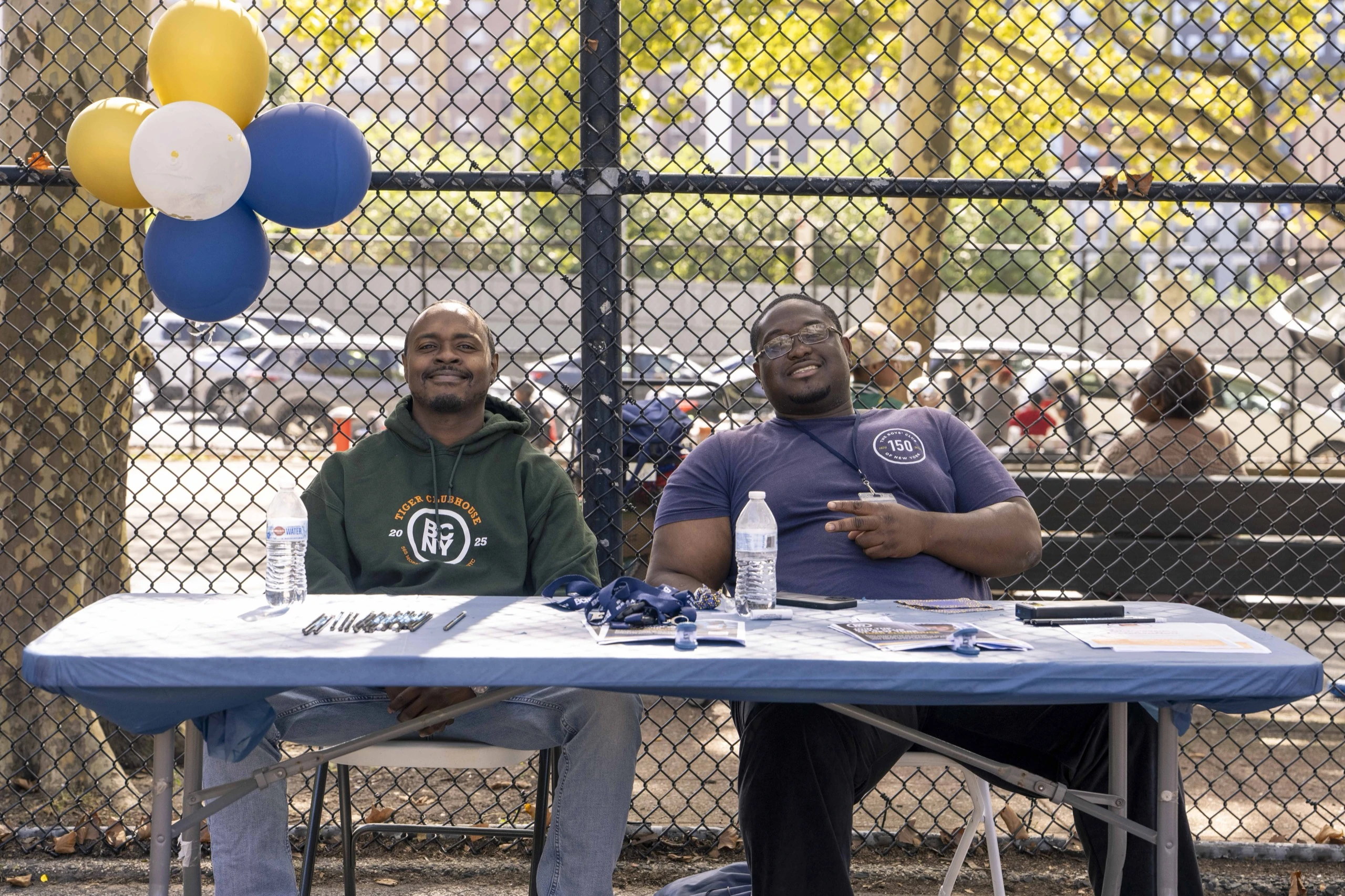 Community members welcome families at an information table