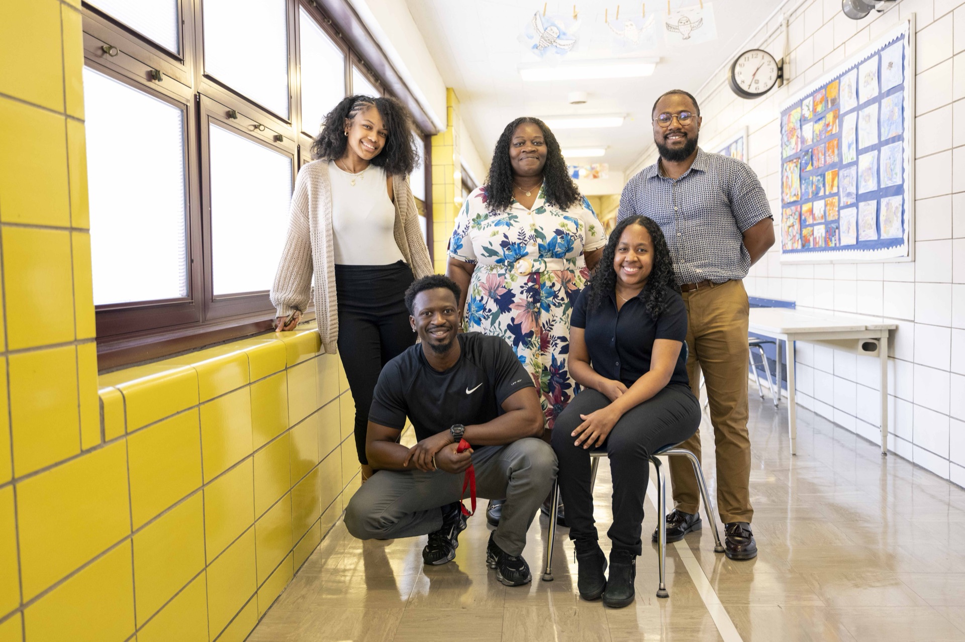 Classical staff members smile together at school.