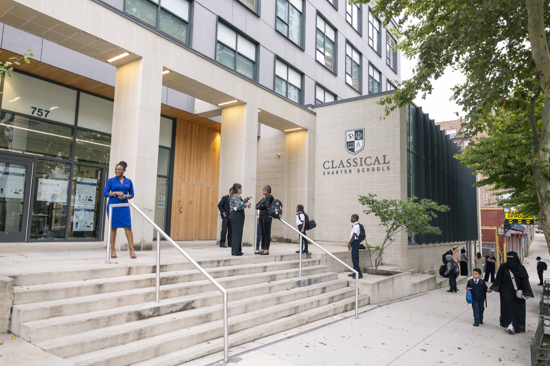 The entrance to South Bronx Classical IV, with staff and families outside.