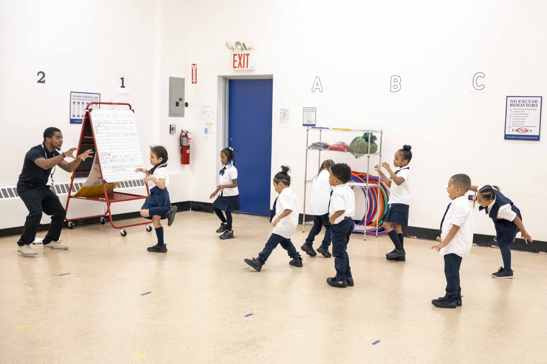 A Classical teacher leads scholars in a movement activity.