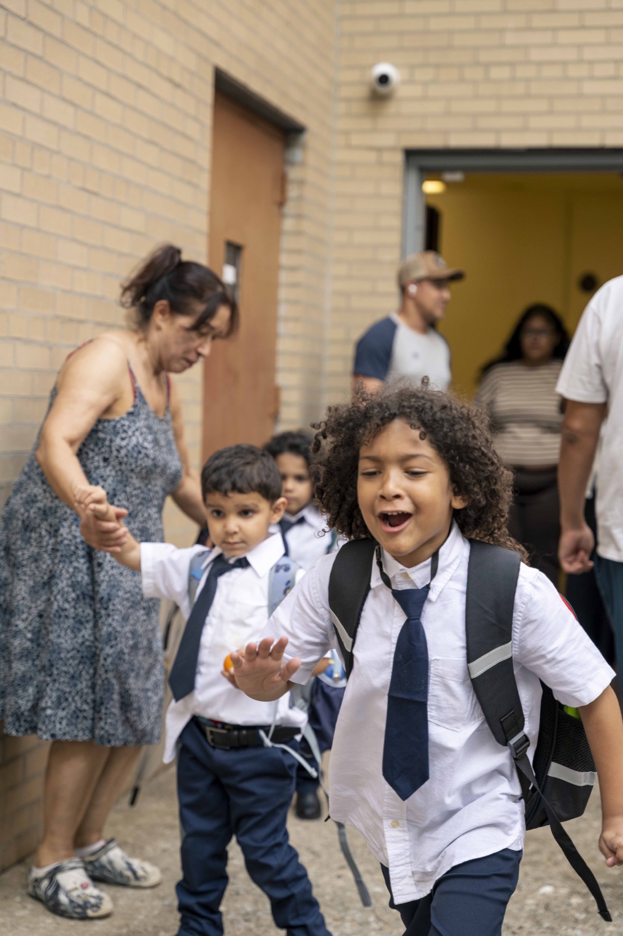 A young Classical scholar leaves school with a backpack.